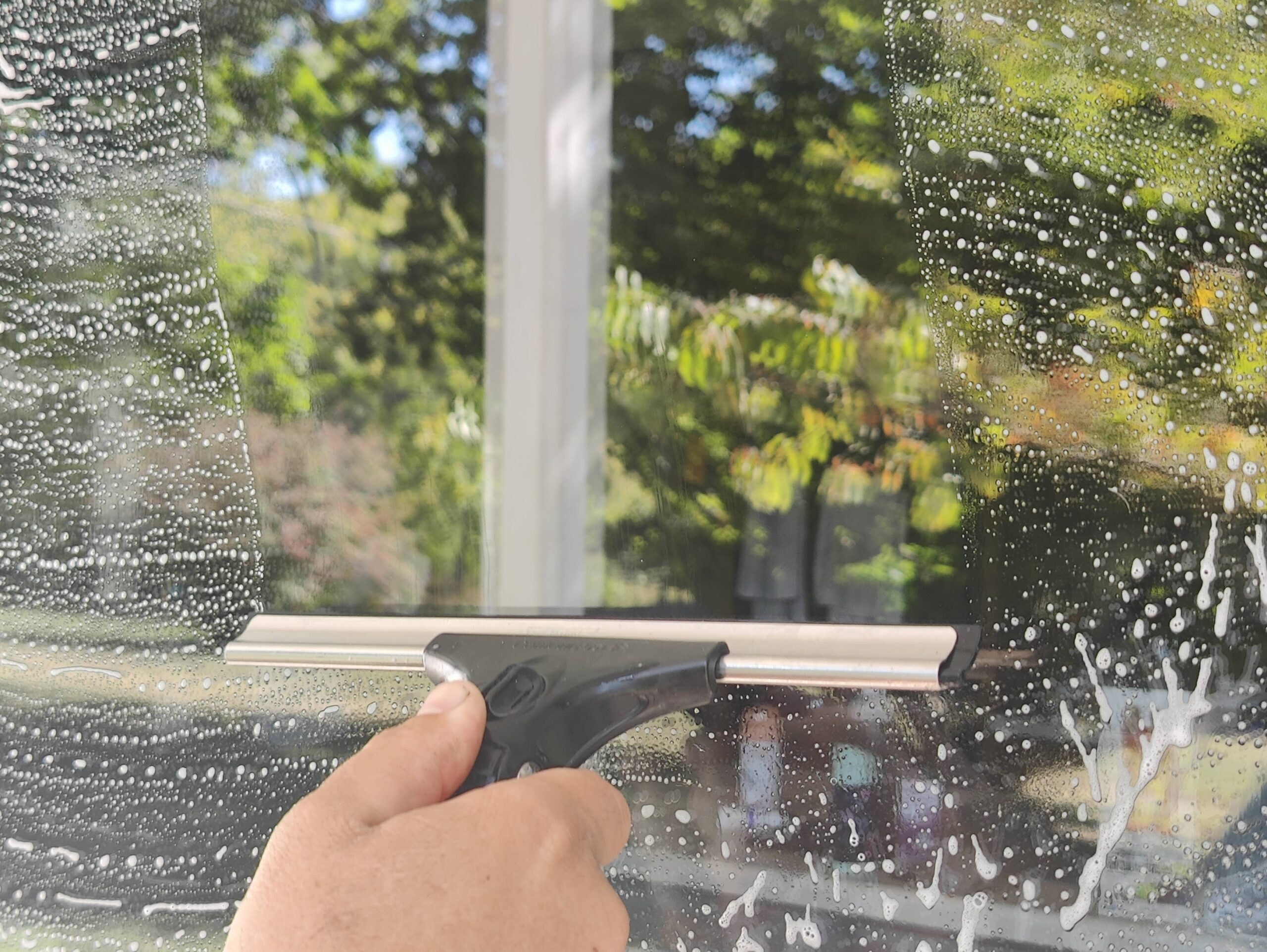 Squeegee on window cleaning soap